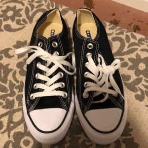 Women’s black and white Converse sneaker